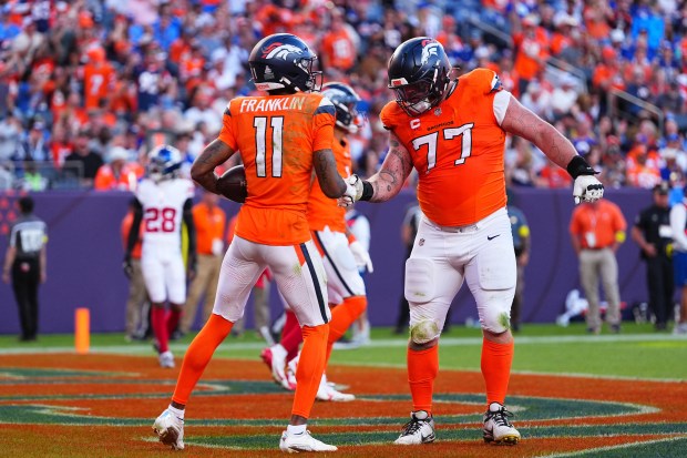 Denver Broncos wide receiver Troy Franklin (11) is congratulated by...
