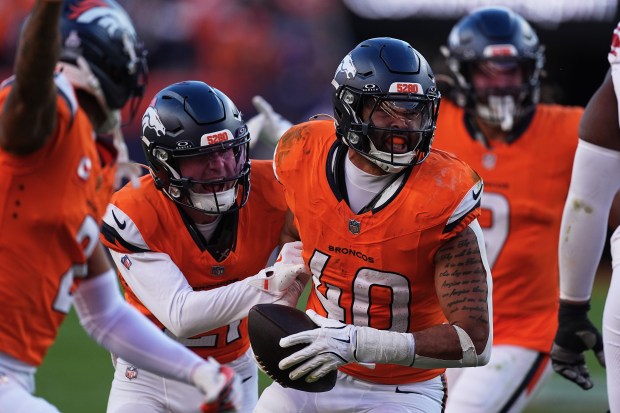 Denver Broncos linebacker Justin Strnad (40) is congratulated by teammates...