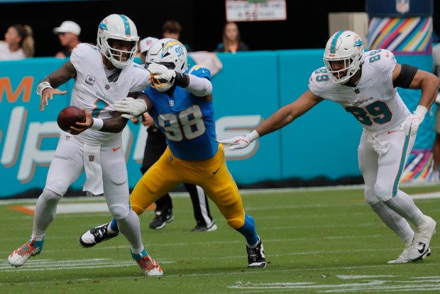 Miami Dolphins quarterback Tua Tagovailoa is sacked by Los Angeles...