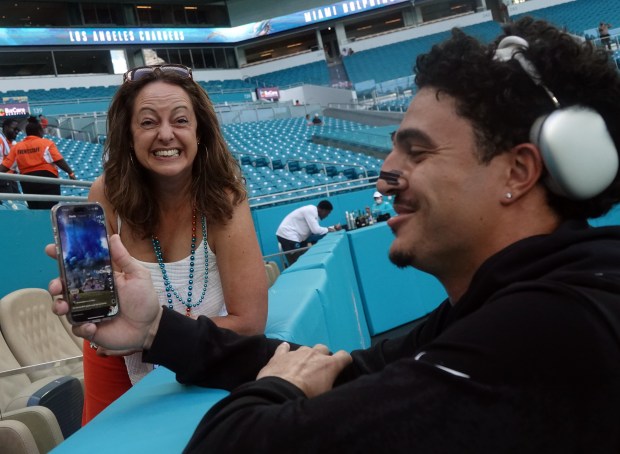 Miami Dolphins fan Gabbi Pack reacts as Miami Dolphins defensive...