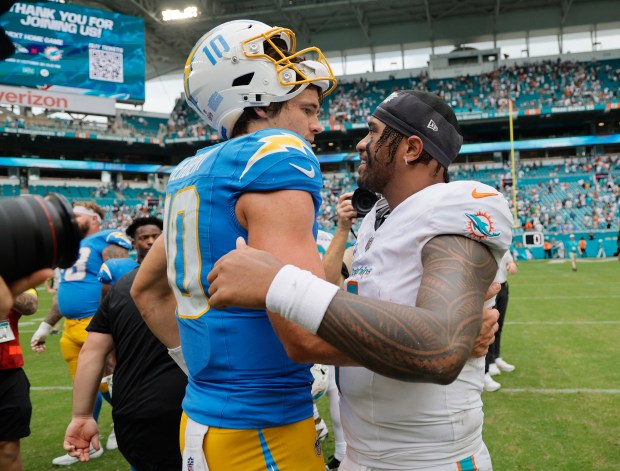 Los Angeles Chargers quarterback Justin Herbert and Miami Dolphins quarterback...