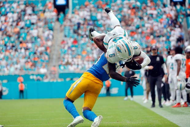 Miami Dolphins wide receiver Malik Washington dives over Los Angeles...