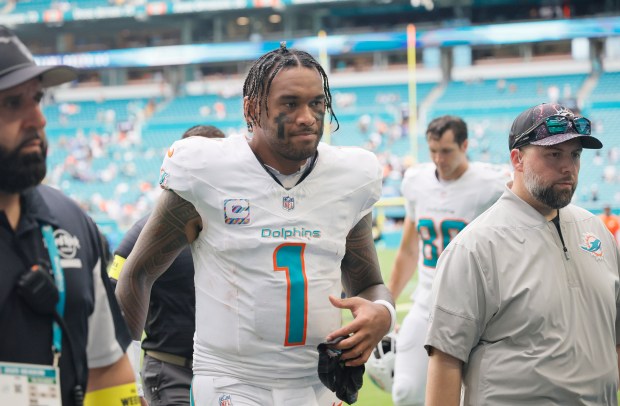 Miami Dolphins quarterback Tua Tagovailoa leaves the field after a...