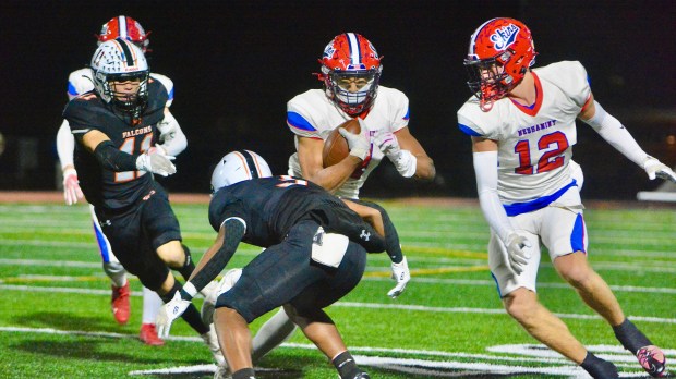 Neshaminy running back Brock Williams, center, carries the ball as...