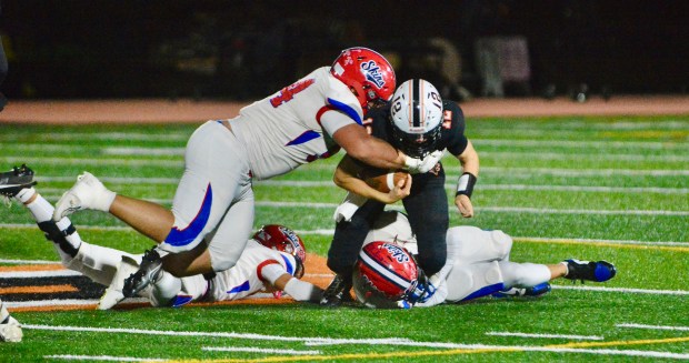 Pennsbury quarterback Jack Arndt, 12, is tackled by Neshaminy’s Dan...