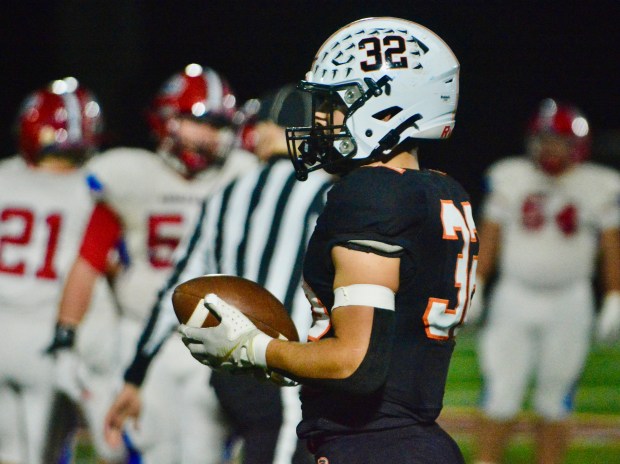 Pennsbury linebacker Justin LaRue-Madison, 32, holds the ball after recovering...