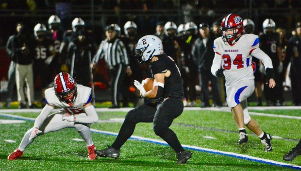 Pennsbury running back Kaiden Brown, center, looks to avoid the...