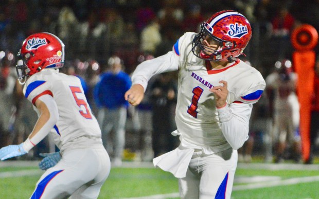 Neshaminy quarterback Michael Eckart, 1, follows through on a pass...