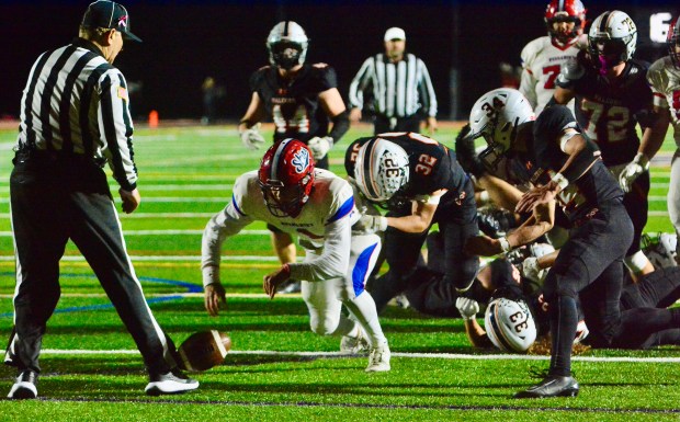 Neshaminy quarterback Michael Eckart, 1, fumbles the ball as he’s...