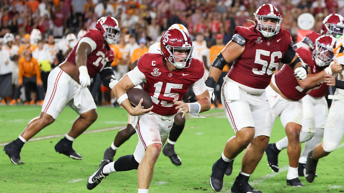 Alabama Crimson Tide quarterback Ty Simpson (15) runs with the ball during the fourth quarter against the Tennessee Volunteers at Saban Field at Bryant-Denny Stadium.