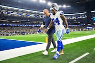 Dallas Cowboys running back Miles Sanders leaves the field after being injured during the...