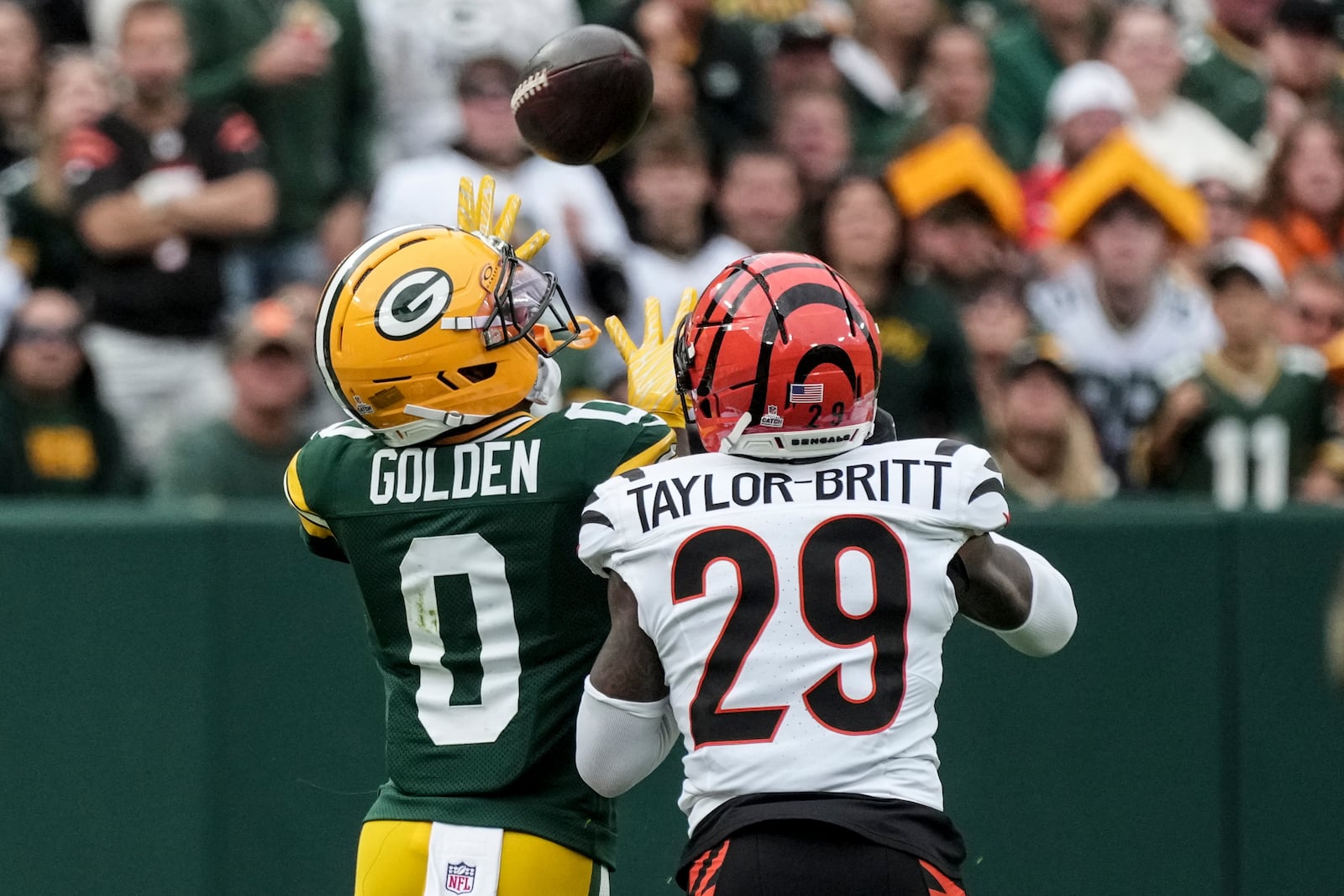 Green Bay Packers' Matthew Golden (0) makes a catch against Cincinnati Bengals cornerback Cam Taylor-Britt (29) in the first half of an NFL football game, Sunday, Oct. 12, 2025, in Green Bay, Wis. (AP Photo/Morry Gash)