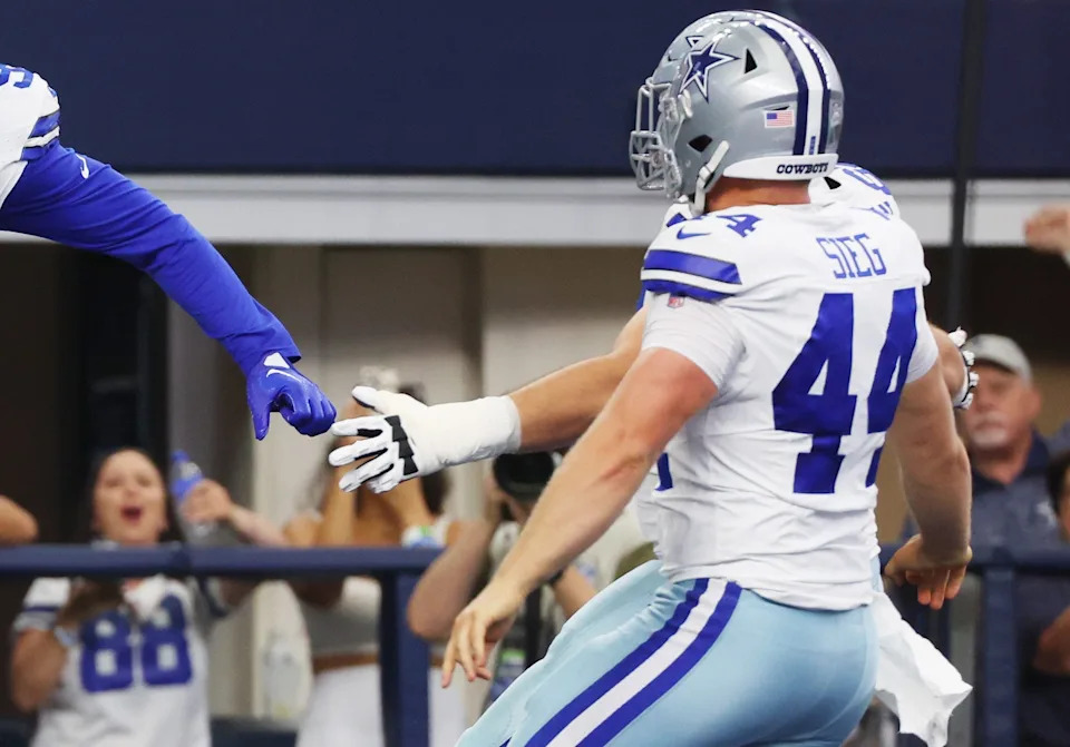 ARLINGTON, TEXAS - OCTOBER 01: Trent Sieg #44 of the Dallas Cowboys celebrates with Chauncey Golston #99 of the Dallas Cowboys after Golston's two point conversion during the second quarter against the New England Patriots at AT&T Stadium on October 01, 2023 in Arlington, Texas. (Photo by Richard Rodriguez/Getty Images)