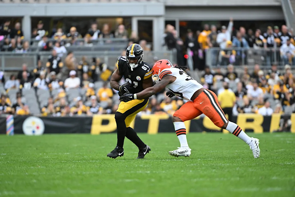 Oct 12, 2025; Pittsburgh, Pennsylvania, USA; Pittsburgh Steelers tight end Jonnu Smith (81) attempts to run the ball against Cleveland Browns linebacker Devin Bush (30) during the fourth quarter at Acrisure Stadium. Mandatory Credit: Barry Reeger-Imagn Images
