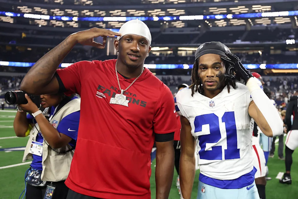 ARLINGTON, TEXAS - AUGUST 22: Michael Penix Jr. #9 of the Atlanta Falcons poses with Malik Davis #21 of the Dallas Cowboys following an NFL Preseason 2025 game at AT&T Stadium on August 22, 2025 in Arlington, Texas. (Photo by Stacy Revere/Getty Images)
