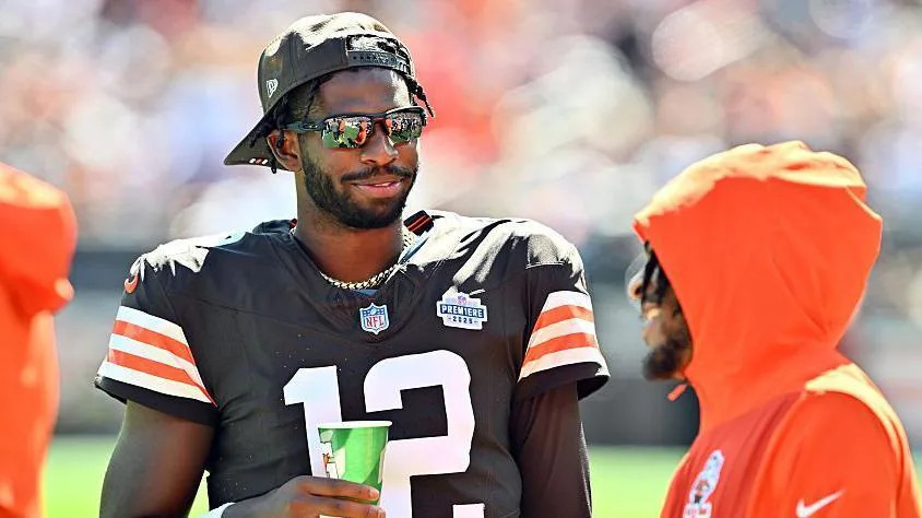 Shedeur Sanders talks to a team-mate on the sidelines during the Cleveland Browns' defeat by the Cincinnati Bengals