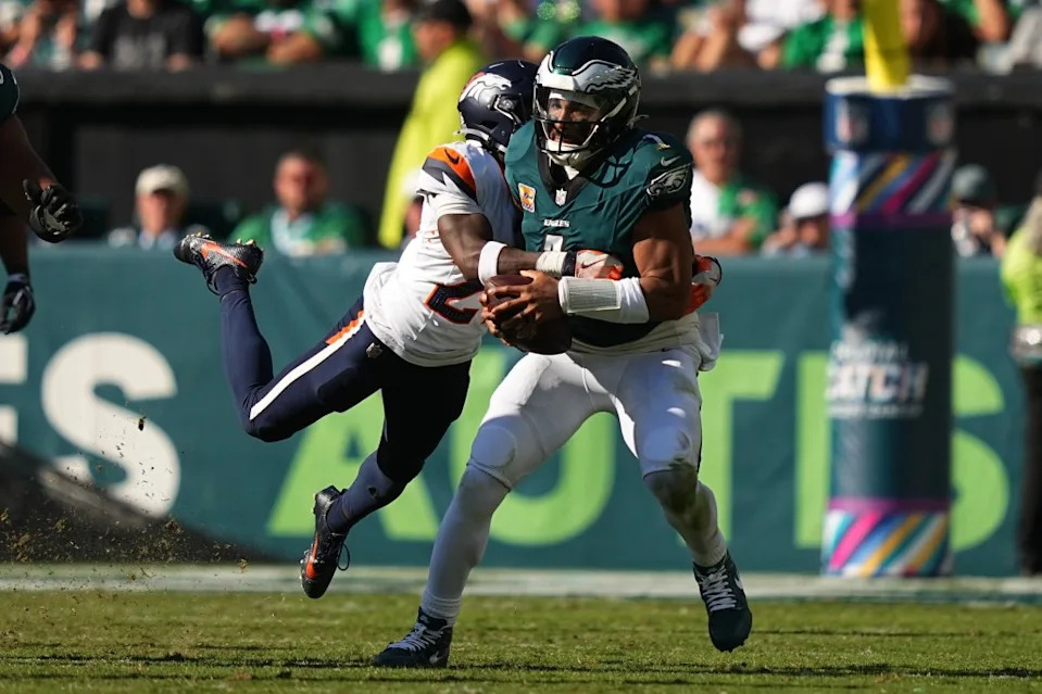 Broncos cornerback Ja’Quan McMillian (29) tackles Philadelphia Eagles quarterback Jalen Hurts (1) during the second half of an NFL football game Sunday, Oct. 5, 2025. AP