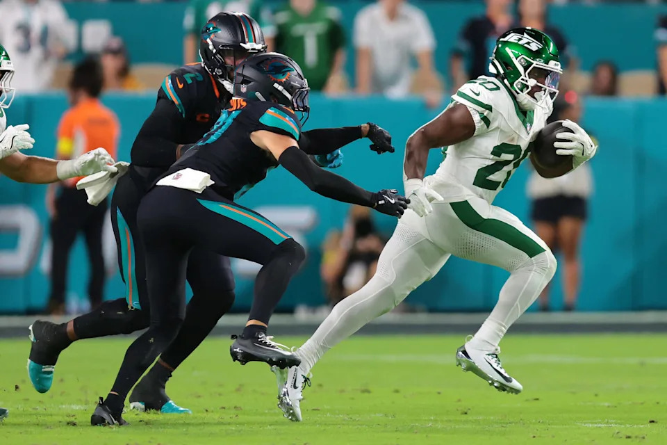 Sep 29, 2025; Miami Gardens, Florida, USA; New York Jets running back Breece Hall (20) rushes the ball against the Miami Dolphins during the first half at Hard Rock Stadium. Mandatory Credit: Sam Navarro-Imagn Images
