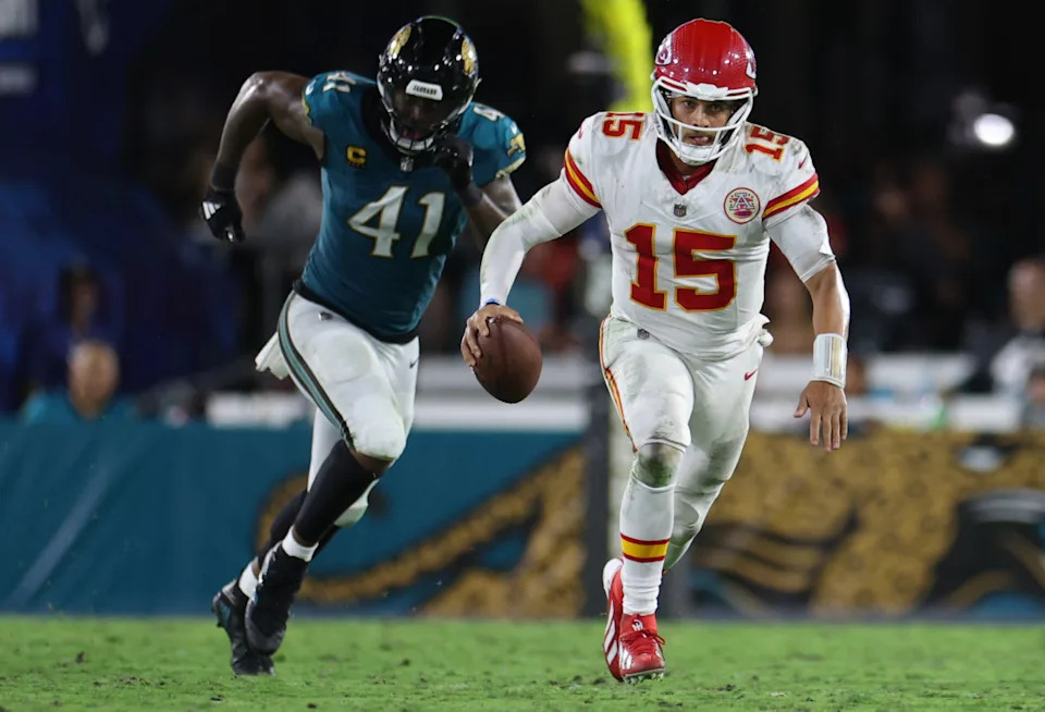 Kansas City Chiefs quarterback Patrick Mahomes (15) scrambles against Jacksonville Jaguars defensive end Josh Hines-Allen (41).Nathan Ray Seebeck-Imagn Images