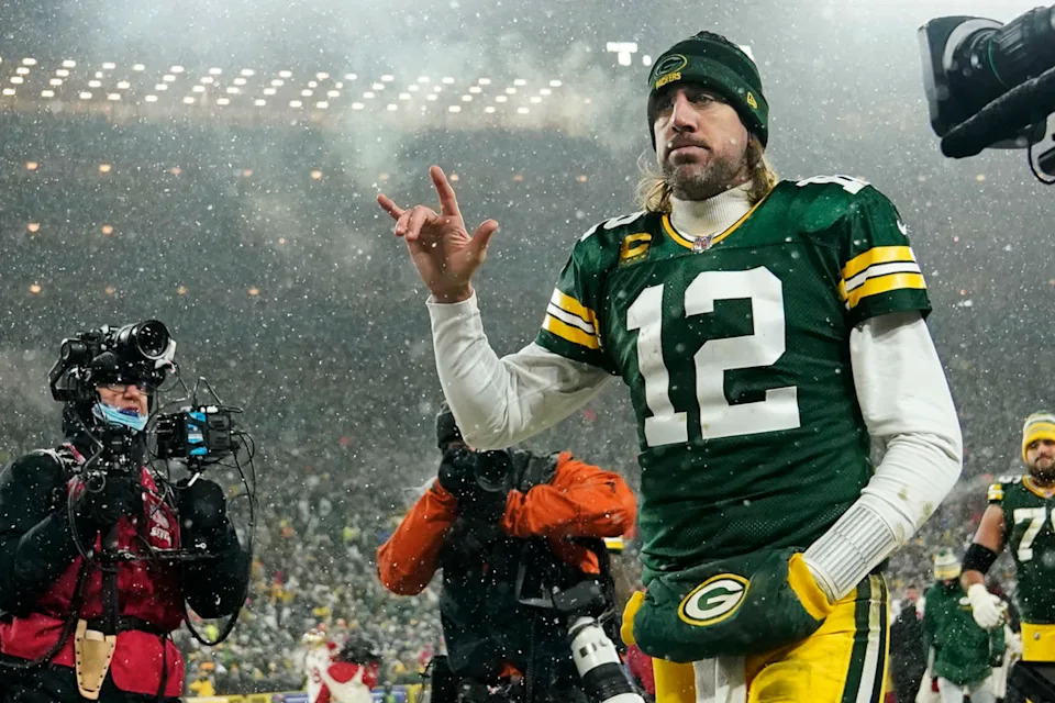 GREEN BAY, WISCONSIN - JANUARY 22: Quarterback Aaron Rodgers #12 of the Green Bay Packers gestures as he exits the field after losing the NFC Divisional Playoff game to the San Francisco 49ers at Lambeau Field on January 22, 2022 in Green Bay, Wisconsin. (Photo by Patrick McDermott/Getty Images)