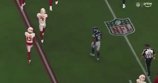 Kenneth Walker III taunts Kei'Trel Clark by tossing the ball at him.