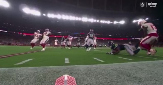 Kenneth Walker III pointing and tossing the ball at Kei’Trel Clark.