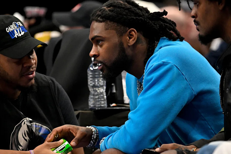 Apr 26, 2024; Dallas, Texas, USA; Dallas Cowboys cornerback Trevon Diggs talks to a member of the Mavericks staff during the second quarter of the game between the Dallas Mavericks and the LA Clippers during game three of the first round for the 2024 NBA playoffs at the American Airlines Center. Mandatory Credit: Jerome Miron-USA TODAY Sports