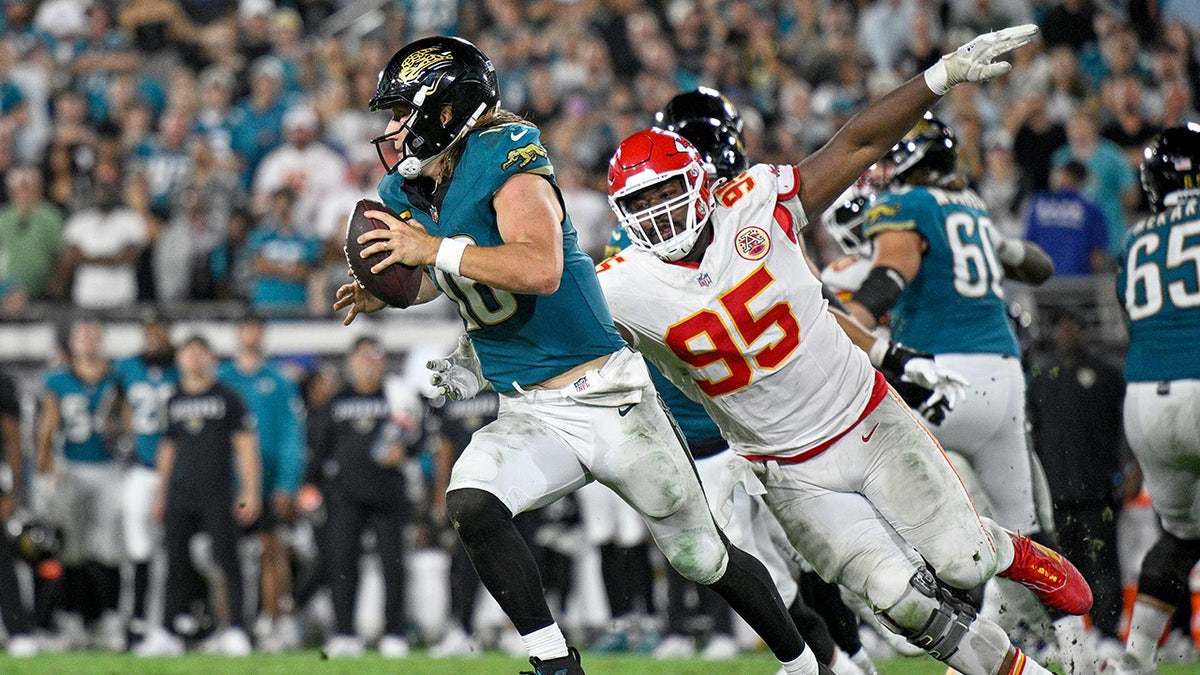 Trevor Lawrence runs past Chris Jones