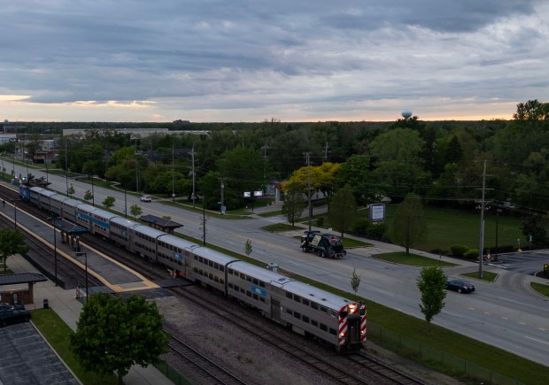 A Metra train stops at the Arlington Park station at sunrise on May 23, 2025, in Arlington Heights. The Bears released projections showing a new stadium in the suburb would generate thousands of jobs and billions of dollars in economic activity, but would also cost $855 million in public funds for infrastructure, such as entrance and exit ramps from near Illinois Route 53 and changes to the adjacent Metra train line. (Stacey Wescott/Chicago Tribune) 