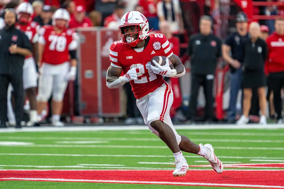 Sep 6, 2025; Lincoln, Nebraska, USA; Nebraska Cornhuskers running back Emmett Johnson (21) runs against the Akron Zips during the second quarter at Memorial Stadium. Mandatory Credit: Dylan Widger-Imagn Images