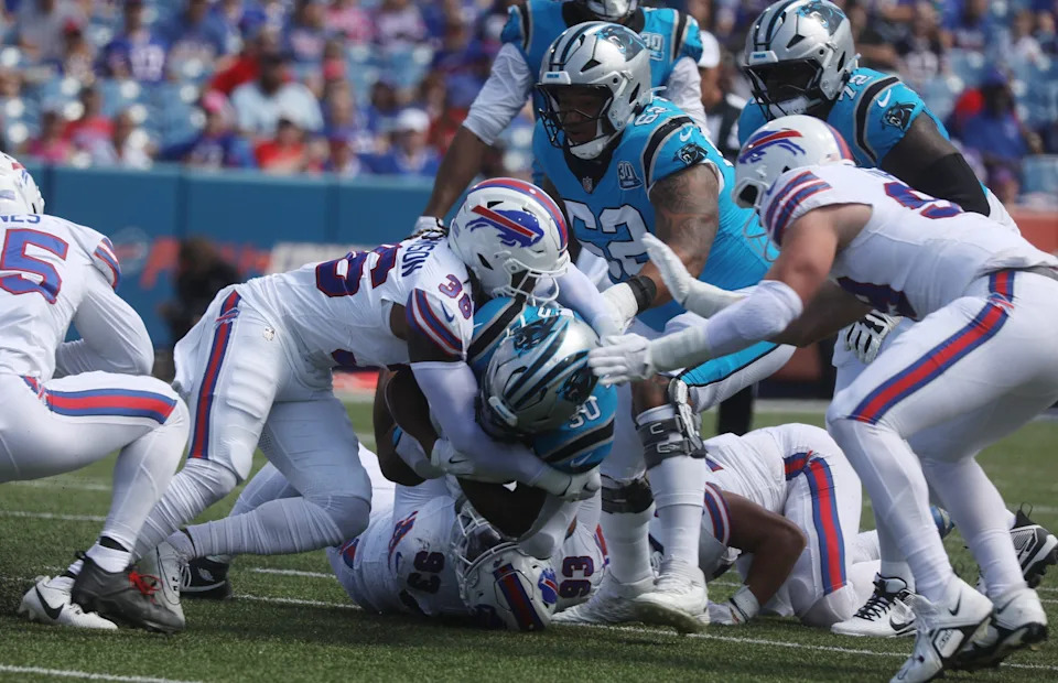 Bills Kendall Williamson and DeShawn Williams tackle Panthers ball carrier Chuba Hubbard during the first half of the preseason game against Carolina Panthers at Highmark Stadium in Orchard Park on Aug. 24, 2024.