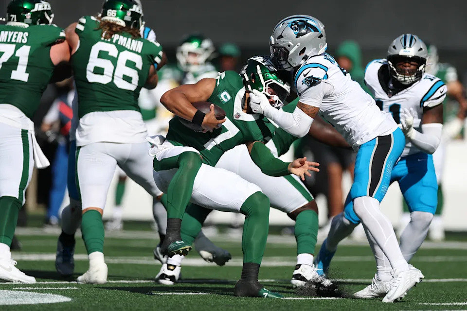 EAST RUTHERFORD, NEW JERSEY - OCTOBER 19: Justin Fields #7 of the New York Jets is sacked by Tre'Von Moehrig #7 of the Carolina Panthers during the second quarter in the game at MetLife Stadium on October 19, 2025 in East Rutherford, New Jersey. (Photo by Al Bello/Getty Images)