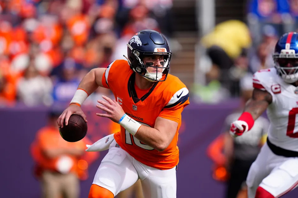 Denver Broncos quarterback Bo Nix runs.