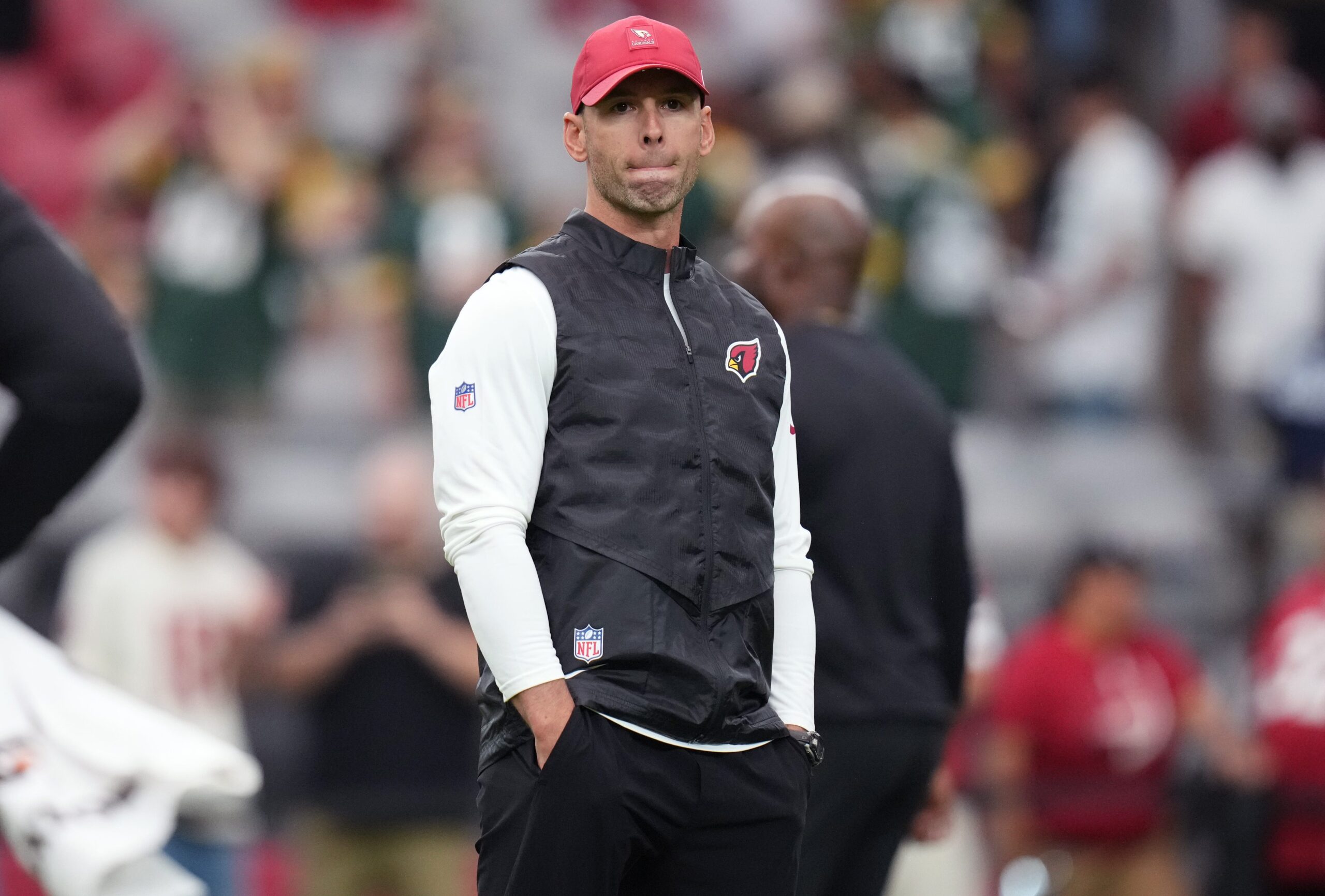 Arizona Cardinals head coach Jonathan Gannon watches as his team warms up before playing against the Green Bay Packers at State Farm Stadium in Glendale.