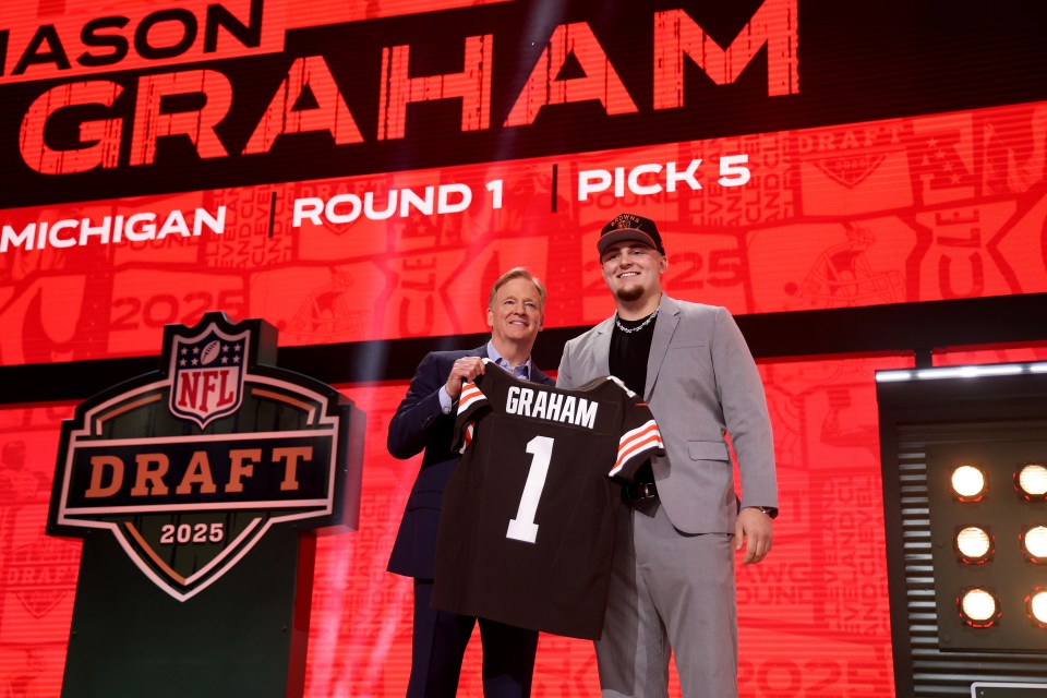 Mason Graham stands next to NFL Commissioner Roger Goodell