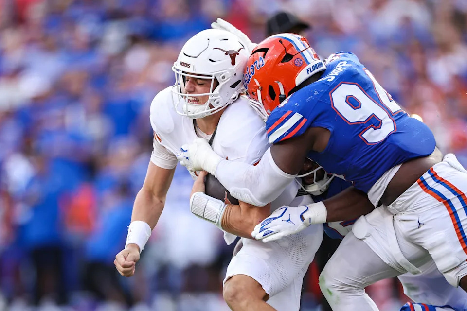 GAINESVILLE, FLORIDA - OCTOBER 04: Arch Manning #16 of the Texas Longhorns is sacked by Tyreak Sapp #94 of the Florida Gators during the second half of a game at Ben Hill Griffin Stadium on October 04, 2025 in Gainesville, Florida. (Photo by James Gilbert/Getty Images)