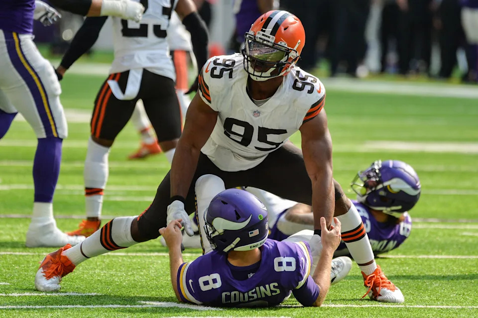 Oct 3, 2021; Minneapolis, Minnesota, USA; Cleveland Browns defensive end Myles Garrett (95) wraps up Minnesota Vikings quarterback Kirk Cousins (8) during the third quarter at U.S. Bank Stadium. Mandatory Credit: Jeffrey Becker-USA TODAY Sports