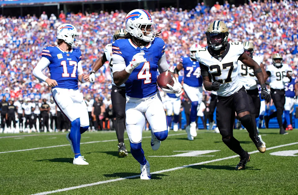 Sep 28, 2025; Orchard Park, New York, USA; Buffalo Bills running back James Cook (4) runs for a gain past New Orleans Saints cornerback Isaac Yiadom (27) during the first quarter at Highmark Stadium. Mandatory Credit: Gregory Fisher-Imagn Images