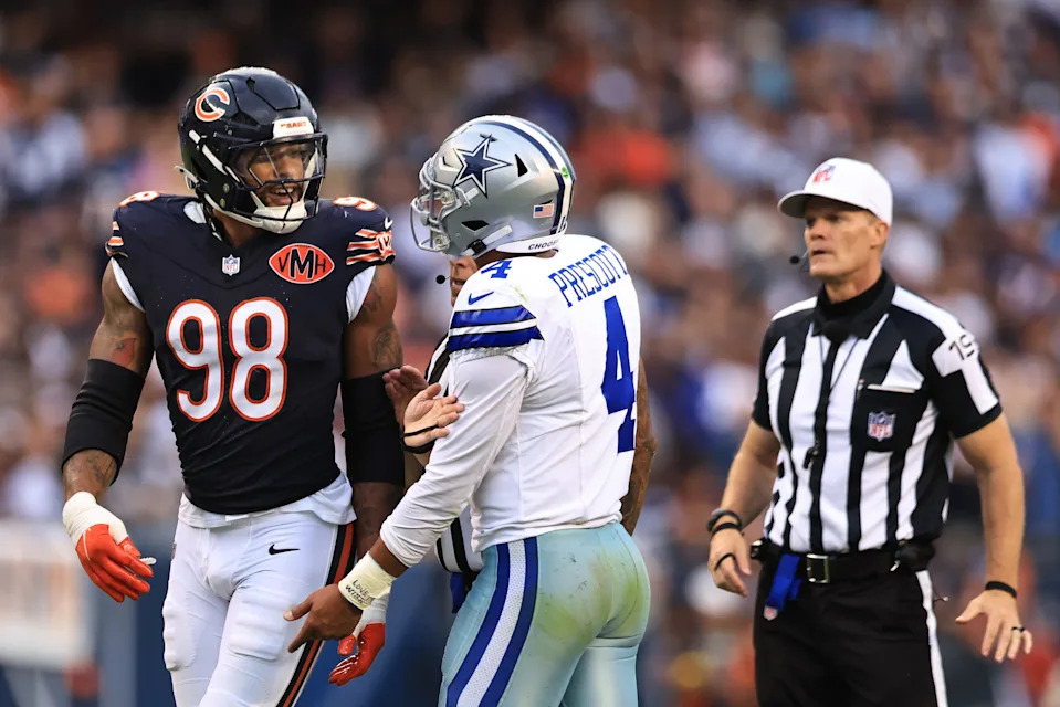 CHICAGO, ILLINOIS - SEPTEMBER 21: Montez Sweat #98 of the Chicago Bears and Dak Prescott #4 of the Dallas Cowboys speak after a play during the fourth quarter at Soldier Field on September 21, 2025 in Chicago, Illinois. (Photo by Geoff Stellfox/Getty Images)