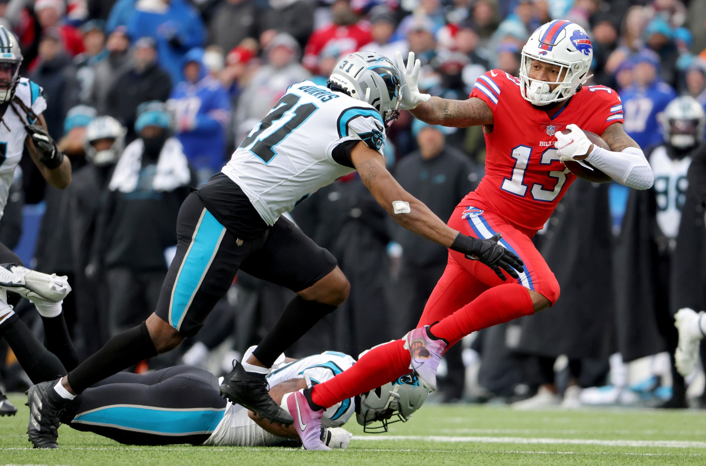ORCHARD PARK, NEW YORK - DECEMBER 19: Gabriel Davis #13 of the Buffalo Bills stiff arms Juston Burris #31 of the Carolina Panthers during a run after a catch in the third quarter of the game at Highmark Stadium on December 19, 2021 in Orchard Park, New York. (Photo by Timothy T Ludwig/Getty Images)