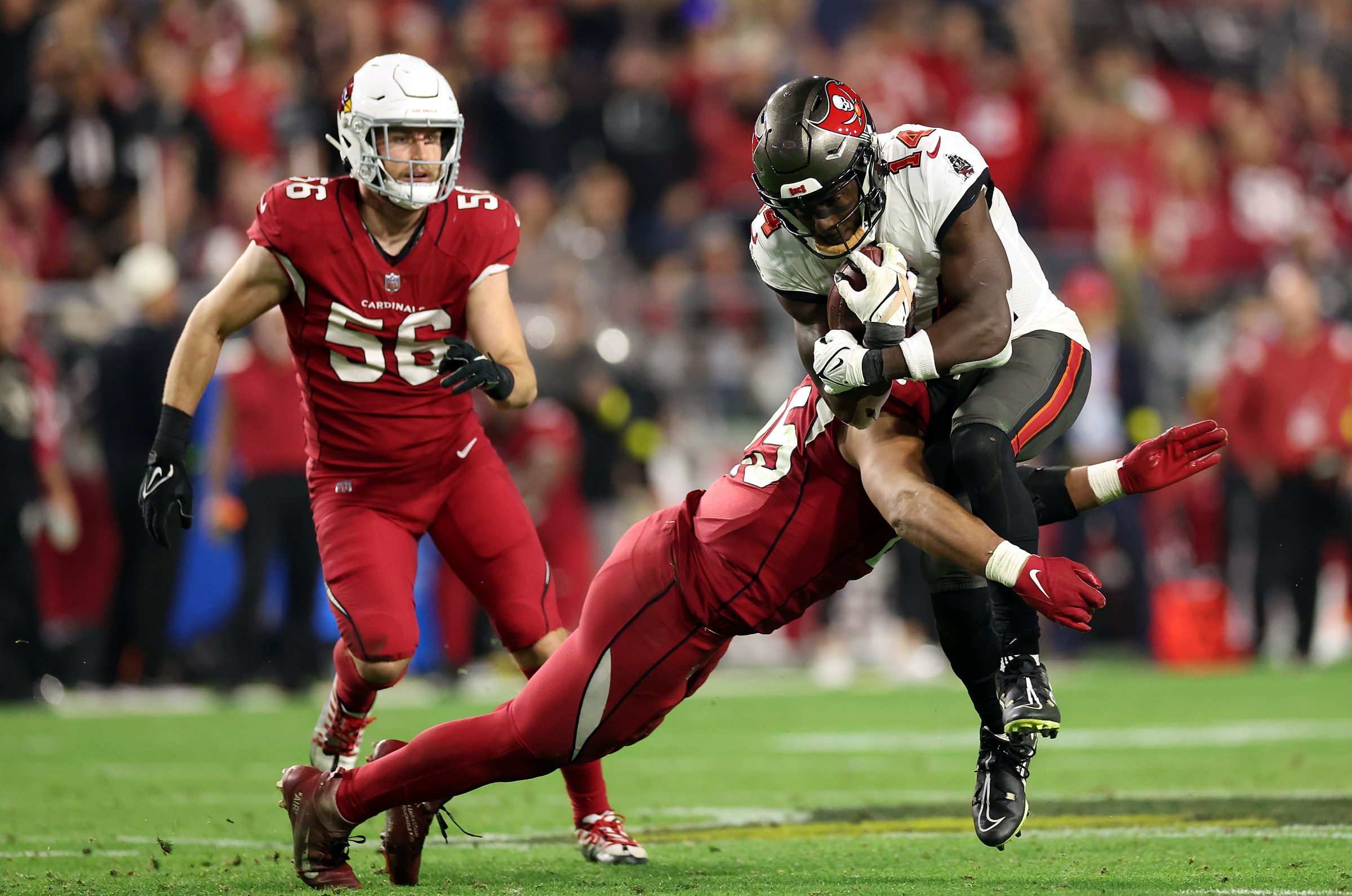 GLENDALE, ARIZONA - DECEMBER 25: Chris Godwin #14 of the Tampa Bay Buccaneers makes a catch for a first down as Zaven Collins #25 of the Arizona Cardinals defends during the 4th quarter of the game at State Farm Stadium on December 25, 2022 in Glendale, Arizona. (Photo by Christian Petersen/Getty Images)