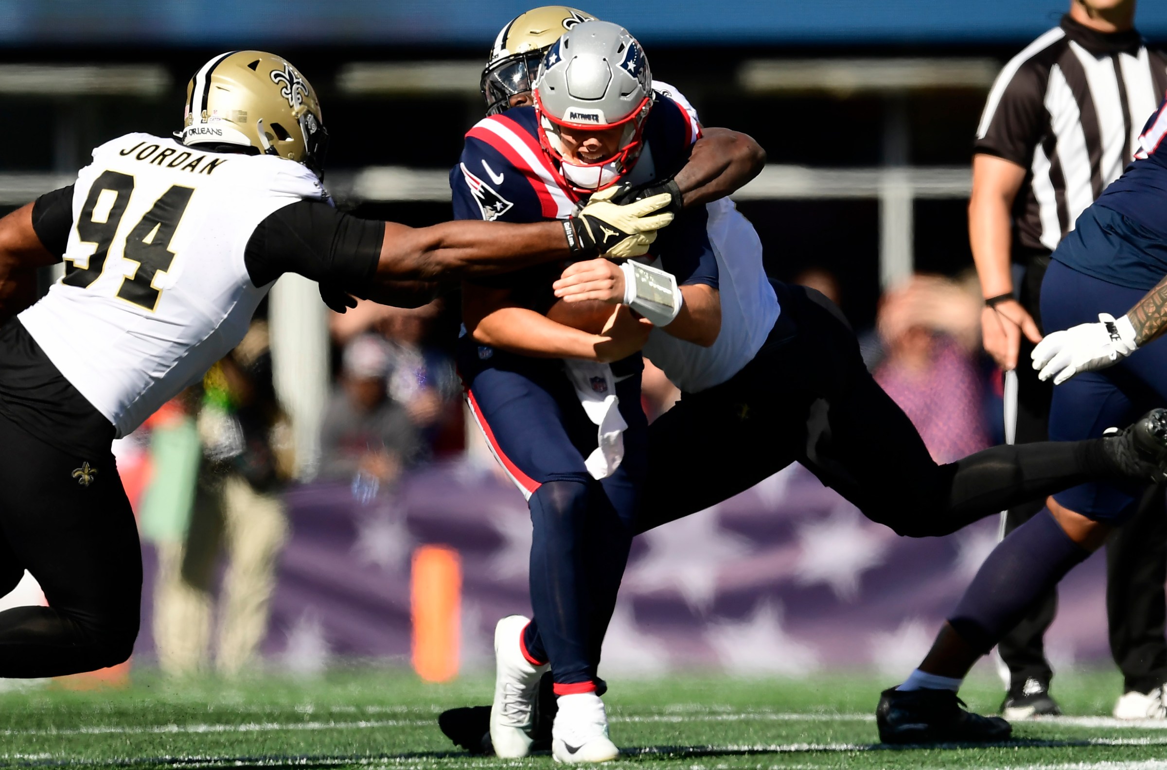FOXBOROUGH, MASSACHUSETTS - OCTOBER 08: Cameron Jordan #94 of the New Orleans Saints and Tanoh Kpassagnon #92 of the New Orleans Saints sack Mac Jones #10 of the New England Patriots during the first half at Gillette Stadium on October 08, 2023 in Foxborough, Massachusetts. (Photo by Maddie Malhotra/Getty Images)