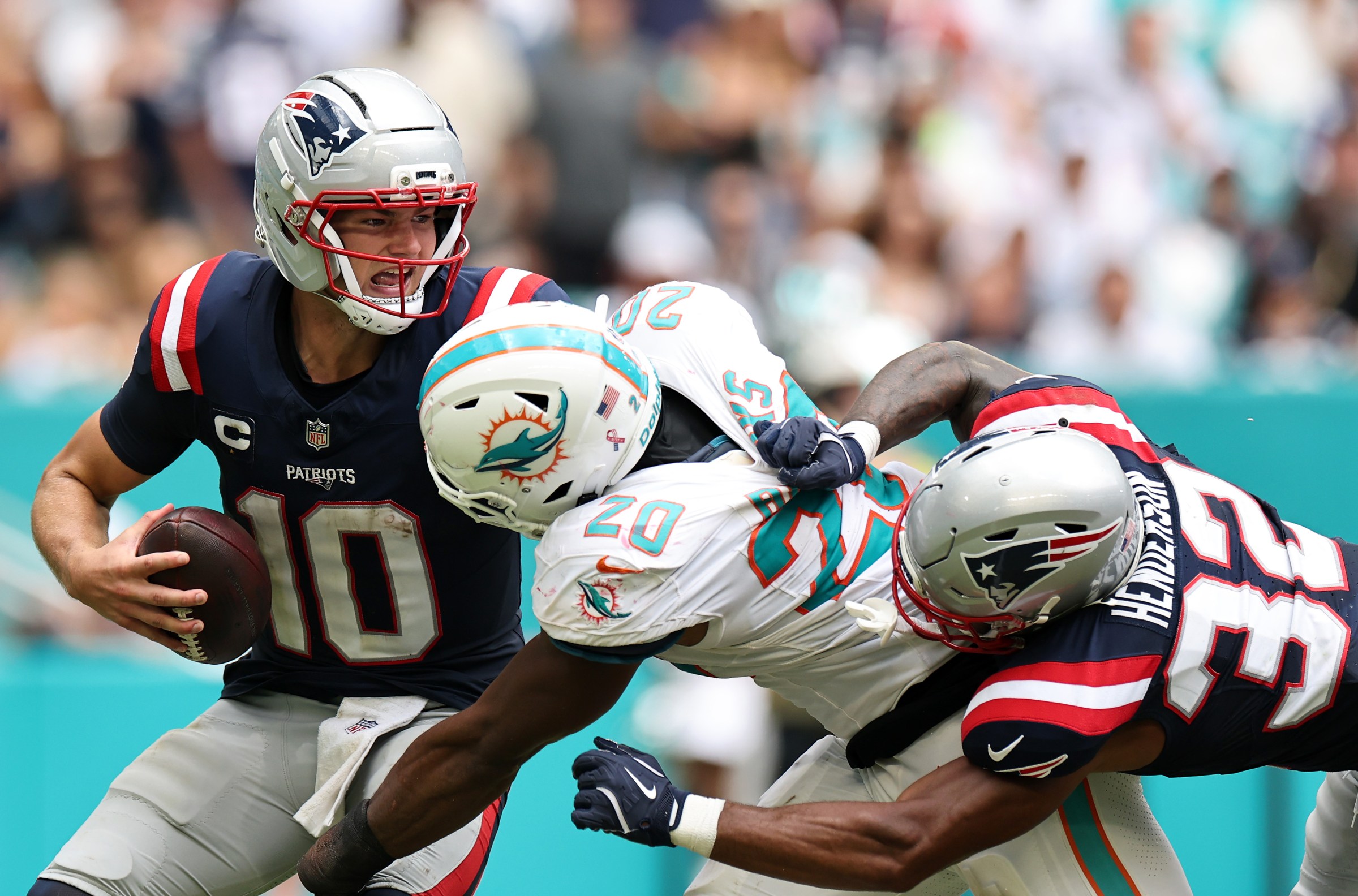 MIAMI GARDENS, FLORIDA - SEPTEMBER 14: Drake Maye #10 of the New England Patriots is under pressure from Jordyn Brooks #20 of the Miami Dolphins during the second half in the game at Hard Rock Stadium on September 14, 2025 in Miami Gardens, Florida. (Photo by Carmen Mandato/Getty Images)