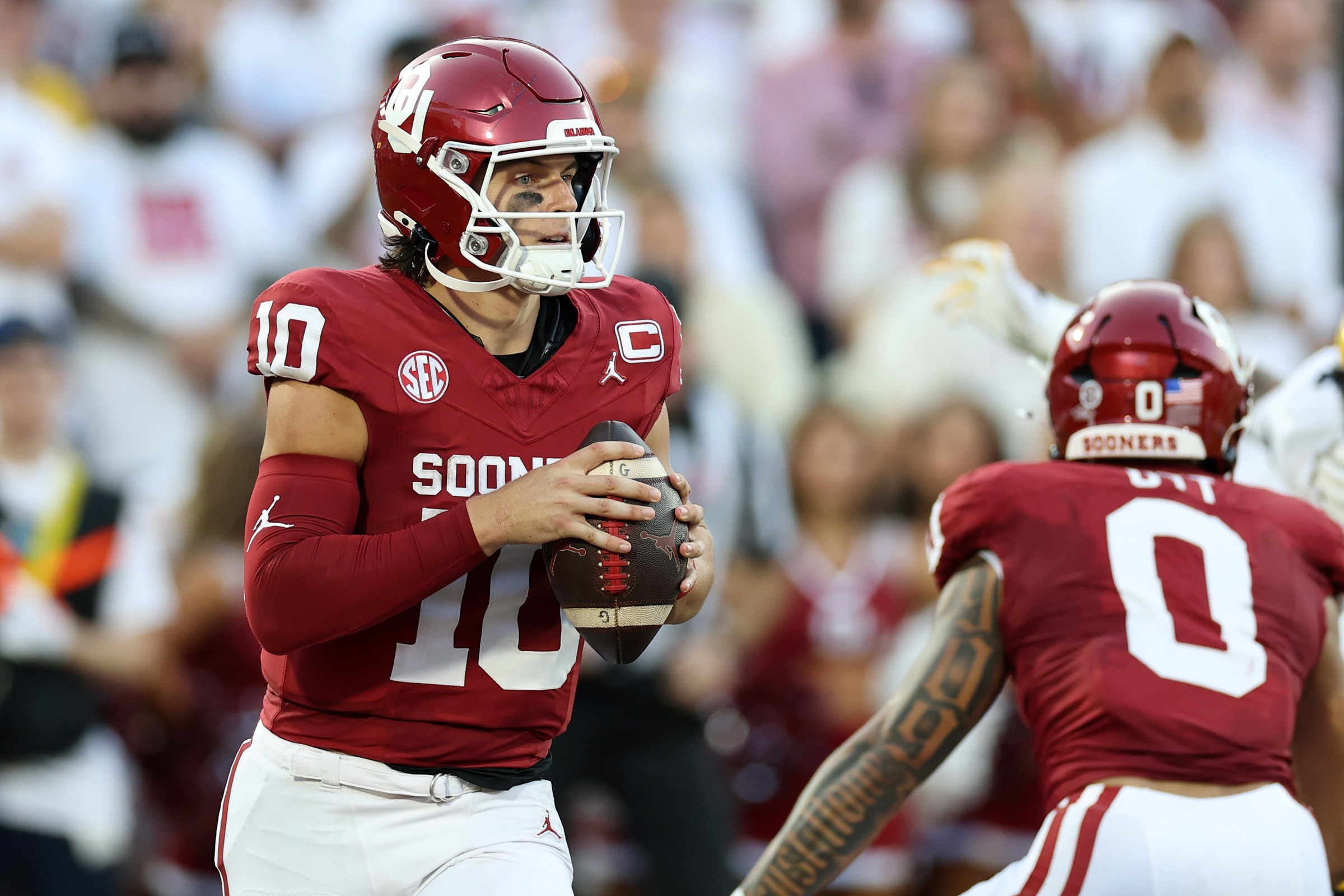 NORMAN, OKLAHOMA - SEPTEMBER 06: John Mateer #10 of the Oklahoma Sooners looks to pass during a game against the Michigan Wolverines at Gaylord Family Oklahoma Memorial Stadium on September 06, 2025 in Norman, Oklahoma. (Photo by Stacy Revere/Getty Images)