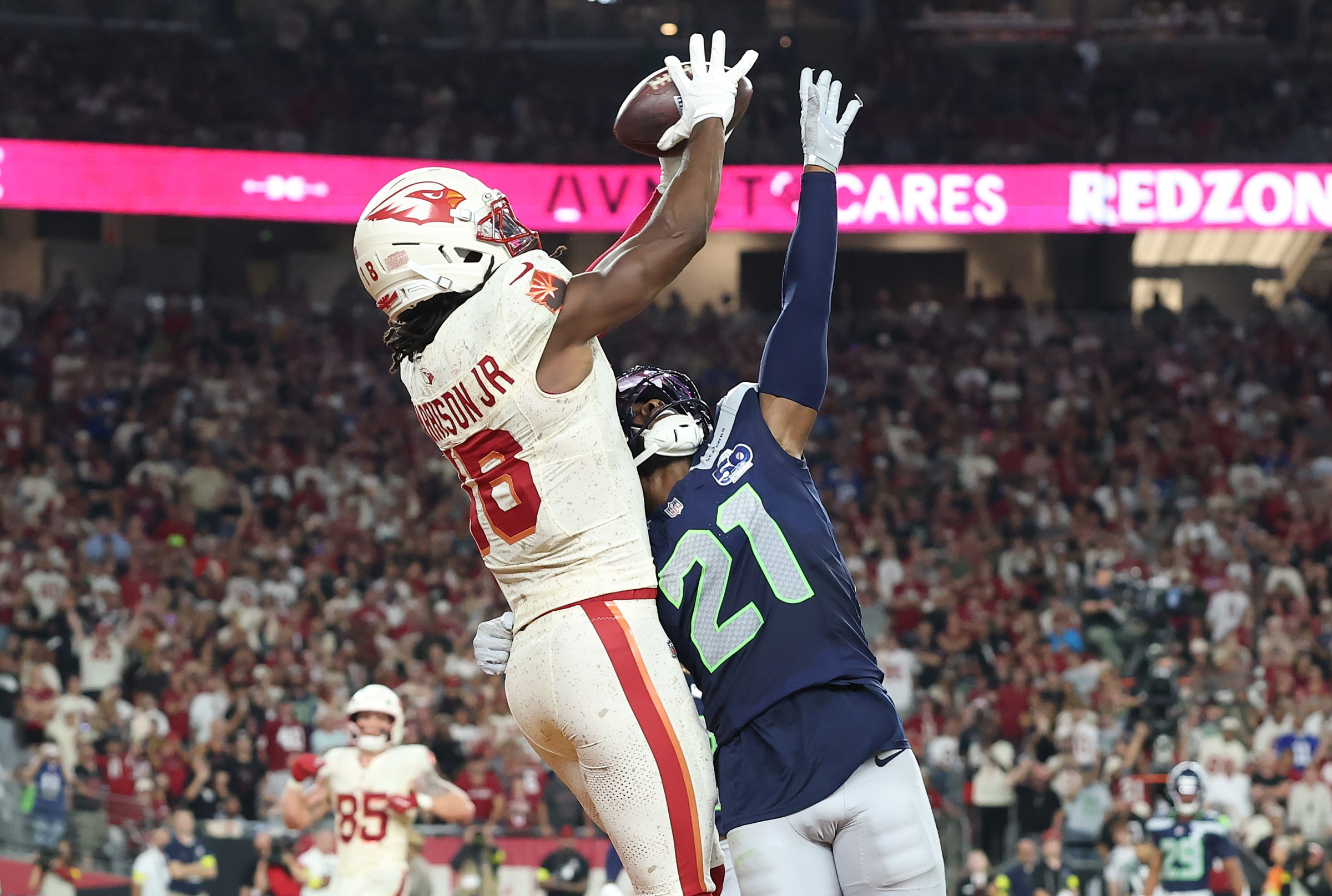 GLENDALE, ARIZONA - SEPTEMBER 25: Marvin Harrison Jr. #18 of the Arizona Cardinals catches a touchdown pass against Devon Witherspoon #21 of the Seattle Seahawks during the fourth quarter of the game at State Farm Stadium on September 25, 2025 in Glendale, Arizona. (Photo by Christian Petersen/Getty Images)