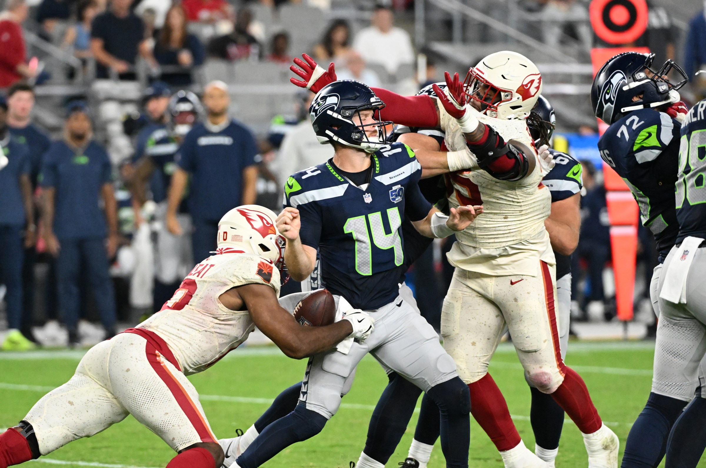 GLENDALE, ARIZONA - SEPTEMBER 25: Josh Sweat #10 of the Arizona Cardinals strips the ball from Sam Darnold #14 of the Seattle Seahawks at State Farm Stadium on September 25, 2025 in Glendale, Arizona. (Photo by Norm Hall/Getty Images)