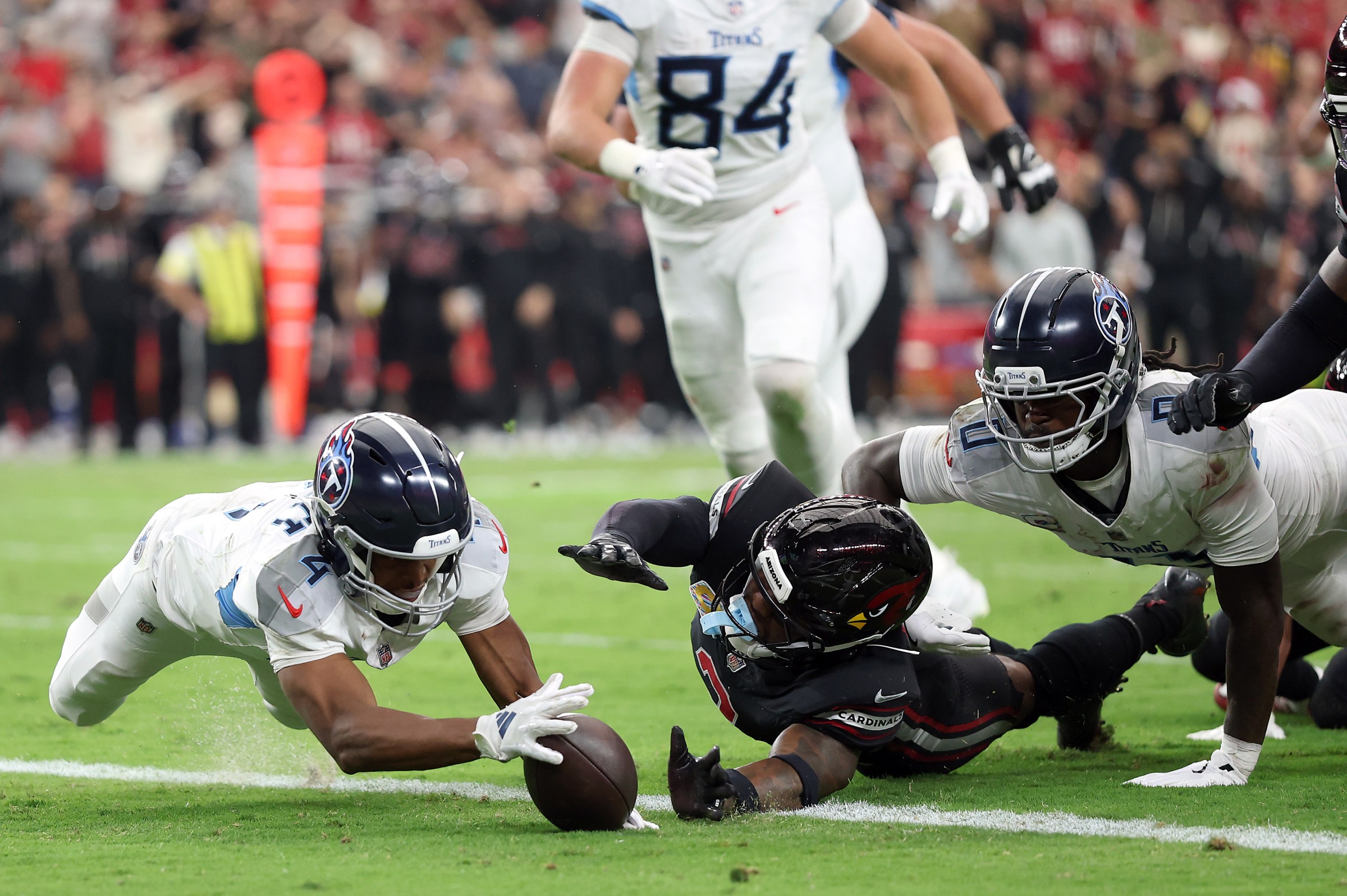 GLENDALE, ARIZONA - OCTOBER 05: Tyler Lockett #4 of the Tennessee Titans recovers a fumble for a touchdown in front of Budda Baker #3 of the Arizona Cardinals during the fourth quarter at State Farm Stadium on October 05, 2025 in Glendale, Arizona. (Photo by Christian Petersen/Getty Images)