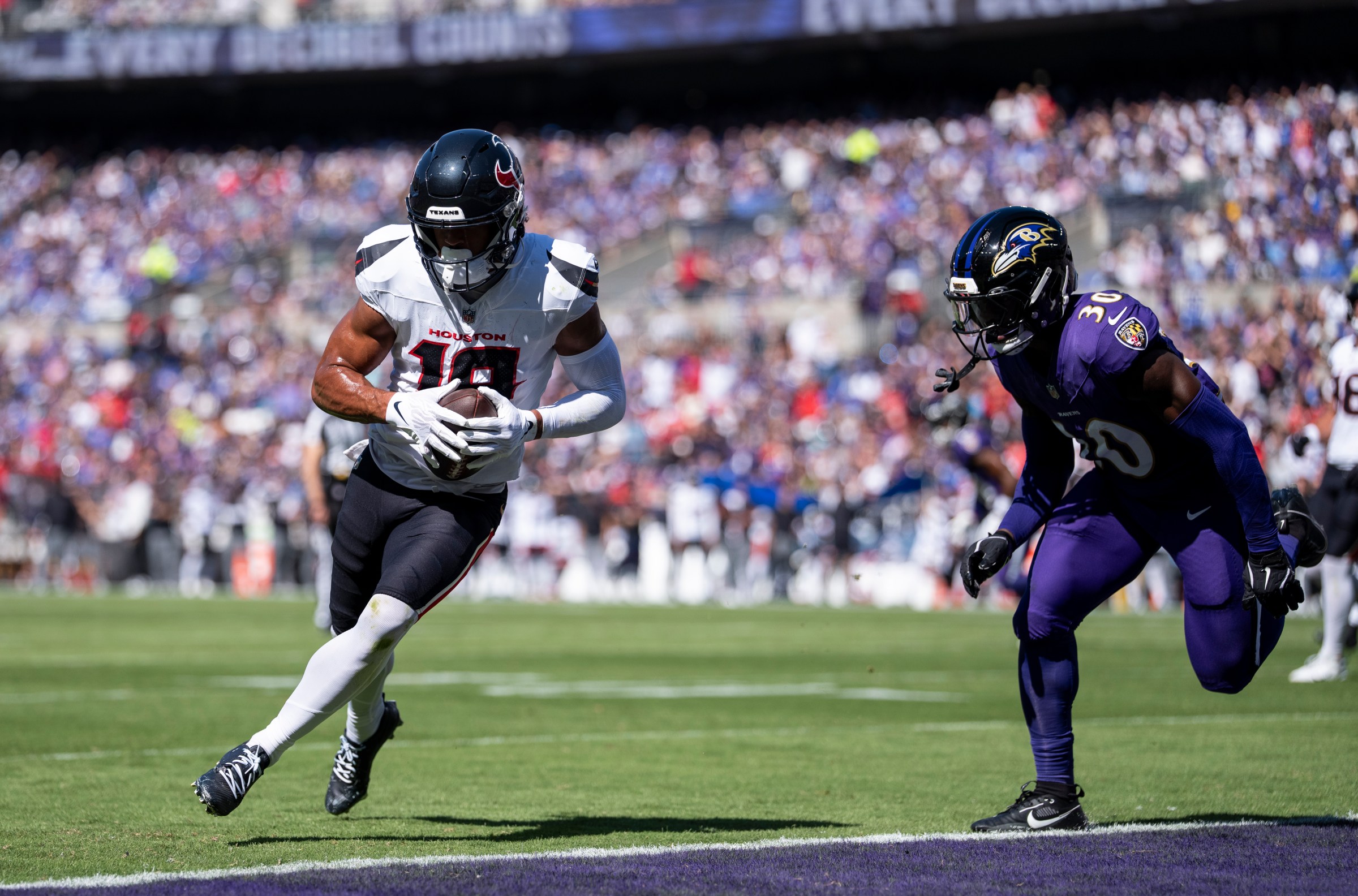 BALTIMORE, MARYLAND - OCTOBER 5: Xavier Hutchinson #19 of the Houston Texans runs with the ball and scores a touchdown during an NFL football game against the Baltimore Ravens at M&T Bank Stadium on October 05, 2025 in Baltimore, Maryland. (Photo by Michael Owens/Getty Images)
