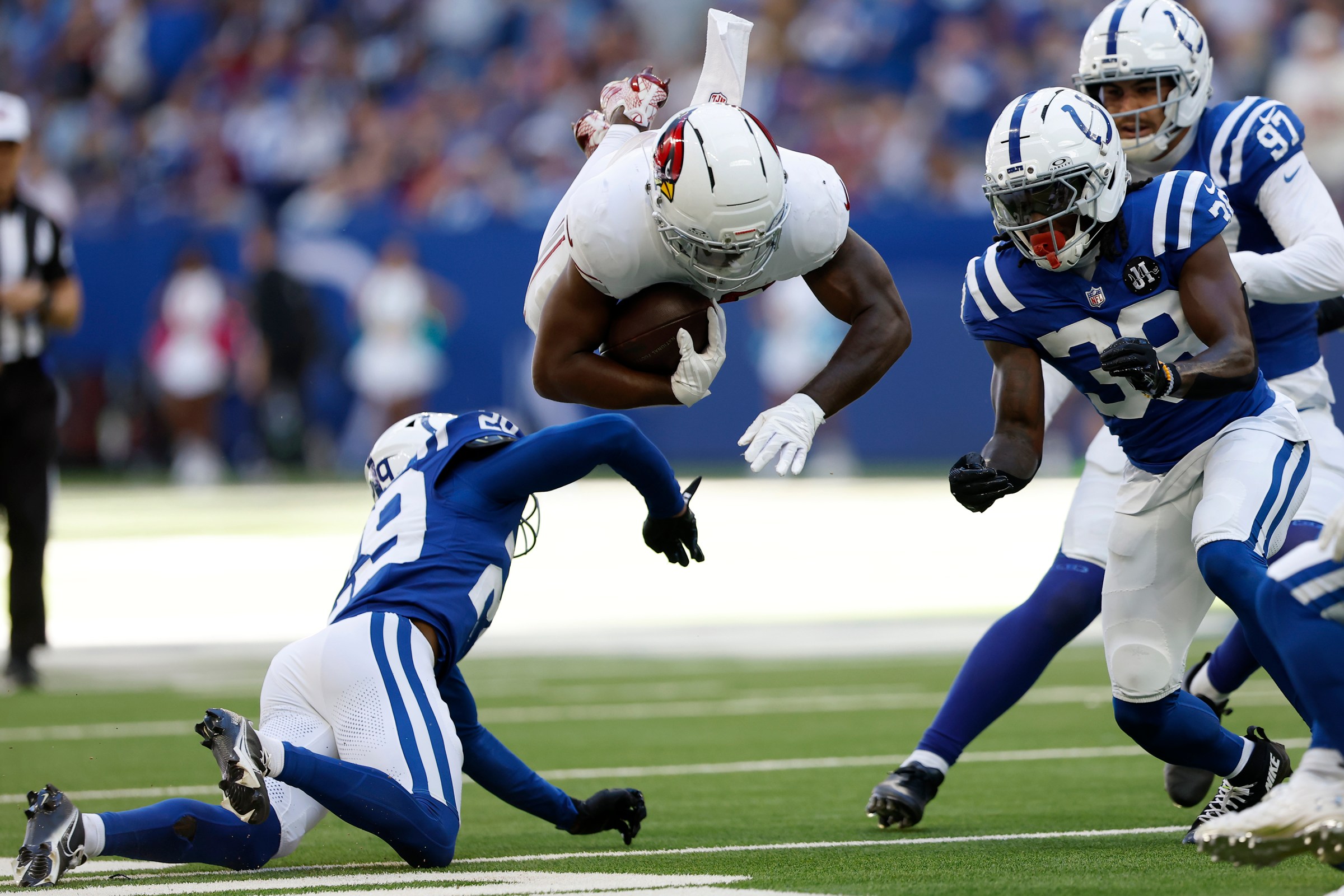 INDIANAPOLIS, IN - OCTOBER 12: Arizona Cardinals running back Bam Knight (20) is up ended by Indianapolis Colts cornerback Mekhi Blackmon (29) during and NFL game between the Indianapolis Colts and the Arizona Cardinals on October 12, 2025 at Lucas Oil Stadium in Indianapolis, IN (Photo by Jeffrey Brown/Icon Sportswire via Getty Images)