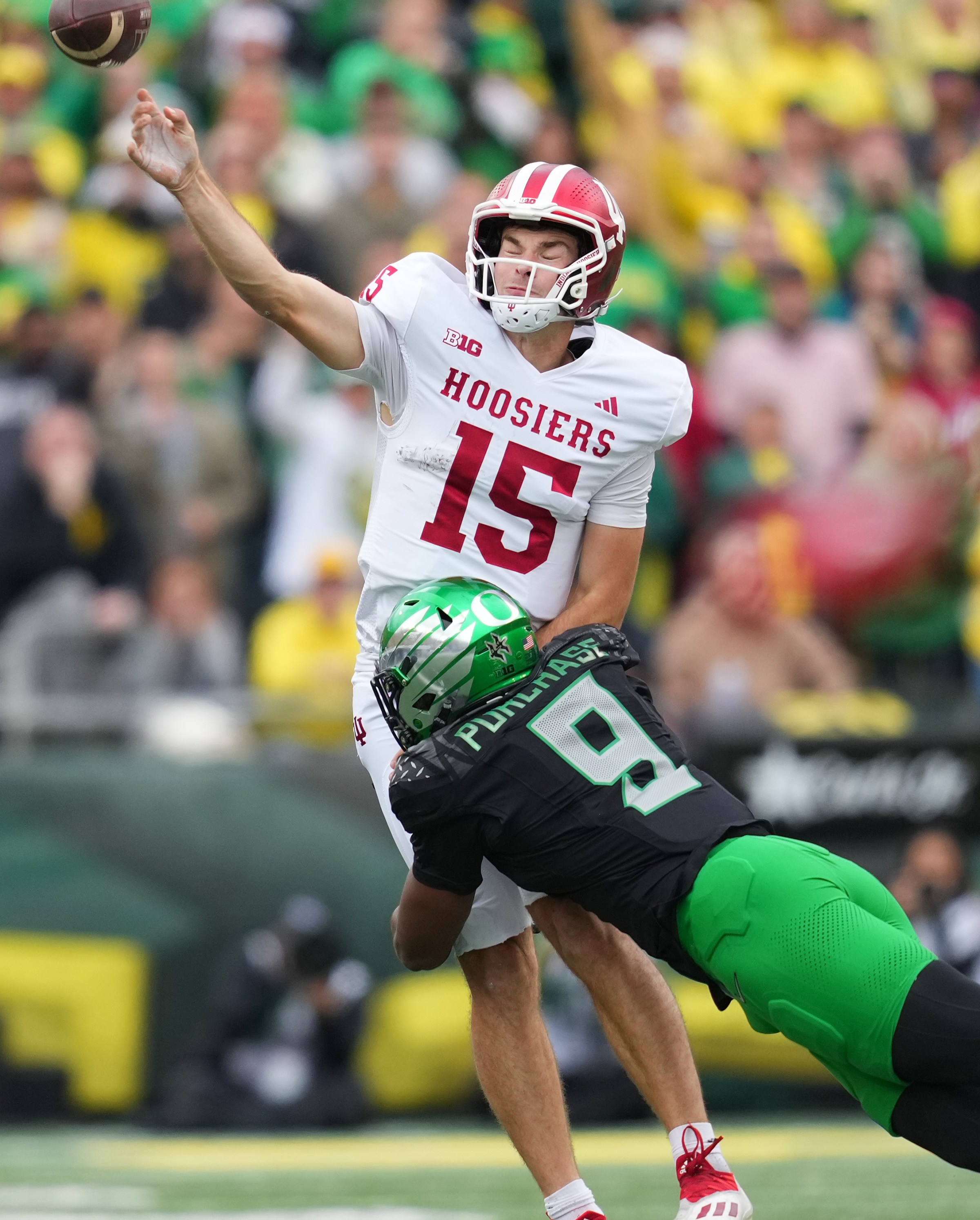 EUGENE, OREGON - OCTOBER 11: Fernando Mendoza #15 of the Indiana Hoosiers throws a pass under pressure from Blake Purchase #9 of the Oregon Ducks during the first half at Autzen Stadium on October 11, 2025 in Eugene, Oregon. (Photo by Soobum Im/Getty Images)